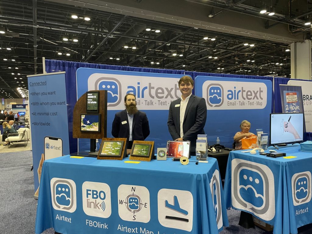 Airtext employees in their trade show booth.